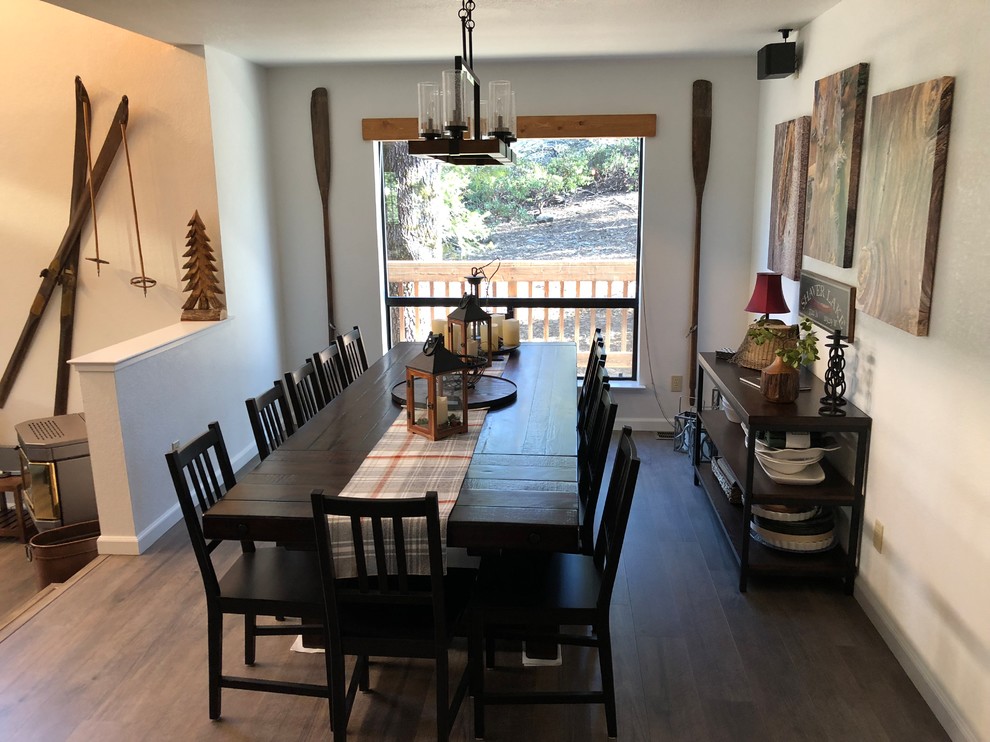 Photo of a mid-sized country dining room in Other with white walls, dark hardwood floors, no fireplace and brown floor.