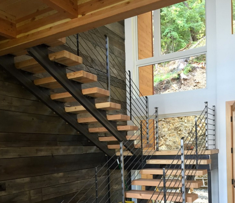 Mid-sized contemporary wood u-shaped staircase in Seattle with open risers.