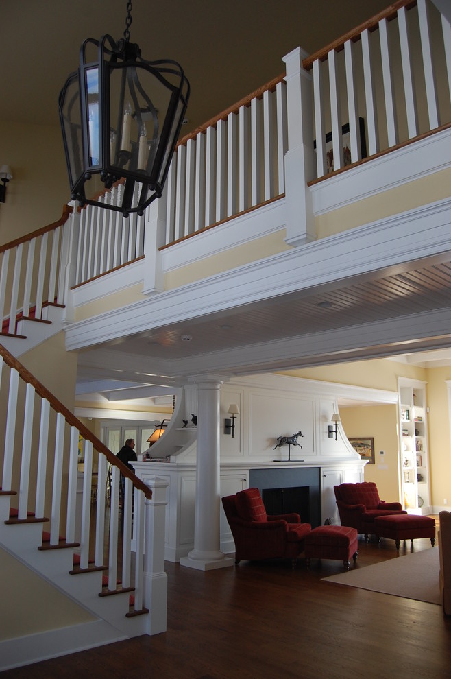 This is an example of an expansive traditional wood u-shaped staircase in Bridgeport with painted wood risers.