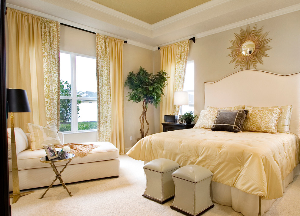 Photo of a transitional bedroom in Orlando with beige walls and carpet.