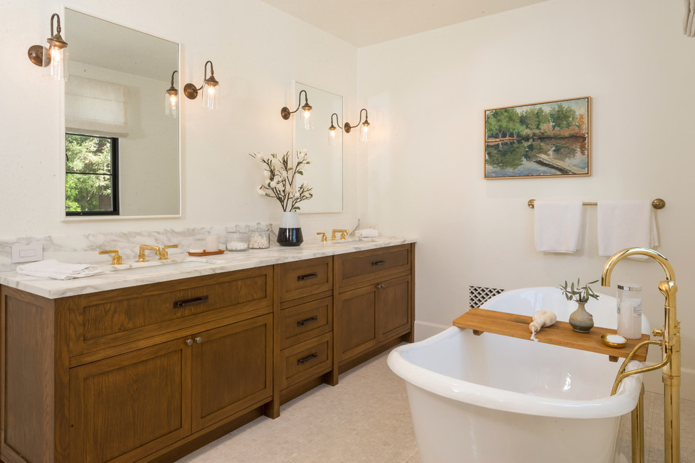 Design ideas for a mediterranean master bathroom in Los Angeles with shaker cabinets, medium wood cabinets, beige walls, an undermount sink, beige floor and multi-coloured benchtops.