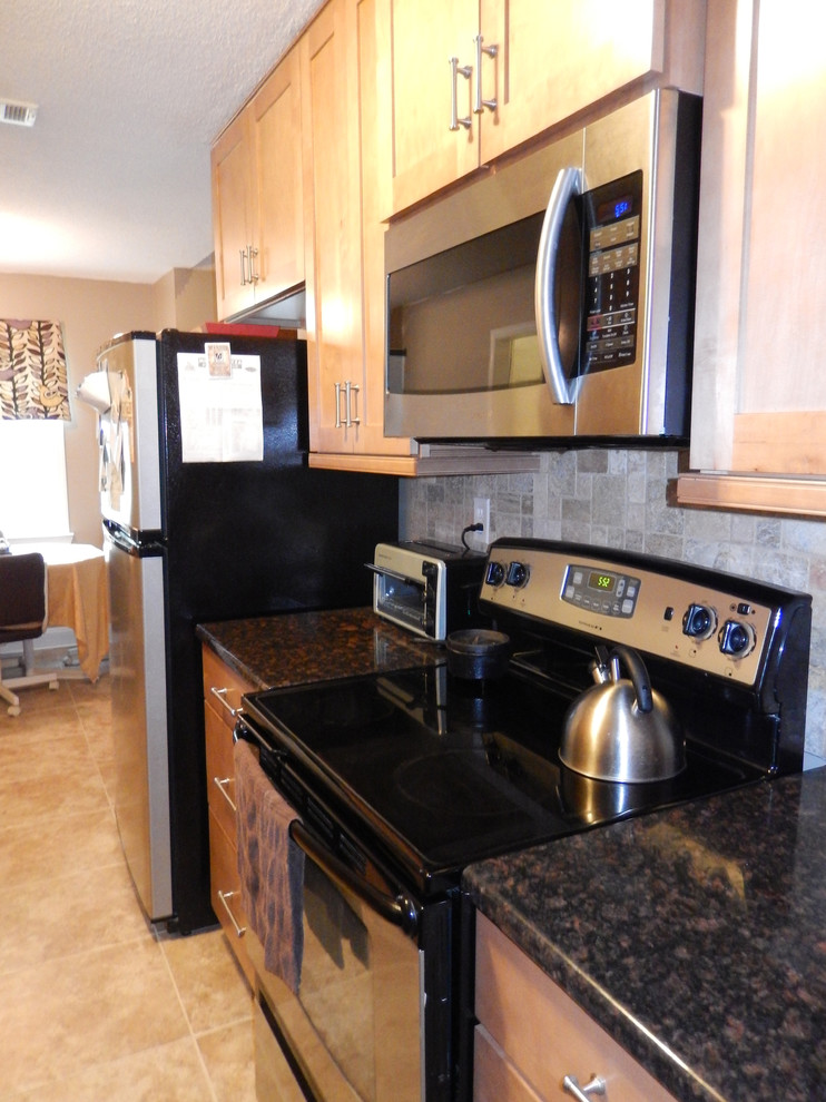 Small transitional galley porcelain tile eat-in kitchen photo with an undermount sink, shaker cabinets, light wood cabinets, laminate countertops, multicolored backsplash, stainless steel appliances, beige walls and no island