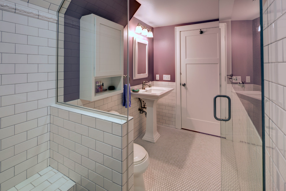Small arts and crafts 3/4 bathroom in Other with a pedestal sink, a curbless shower, a two-piece toilet, white tile, subway tile, purple walls and mosaic tile floors.