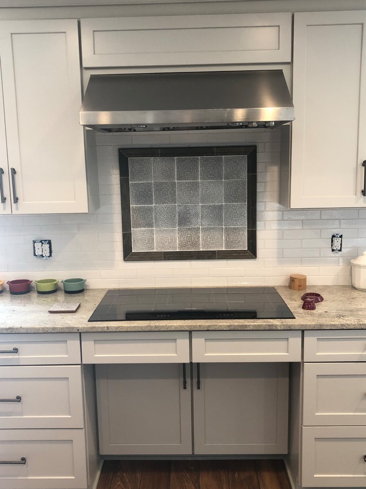 Kitchen - mid-sized transitional kitchen idea with an undermount sink, recessed-panel cabinets, quartz countertops, gray backsplash, subway tile backsplash and gray countertops