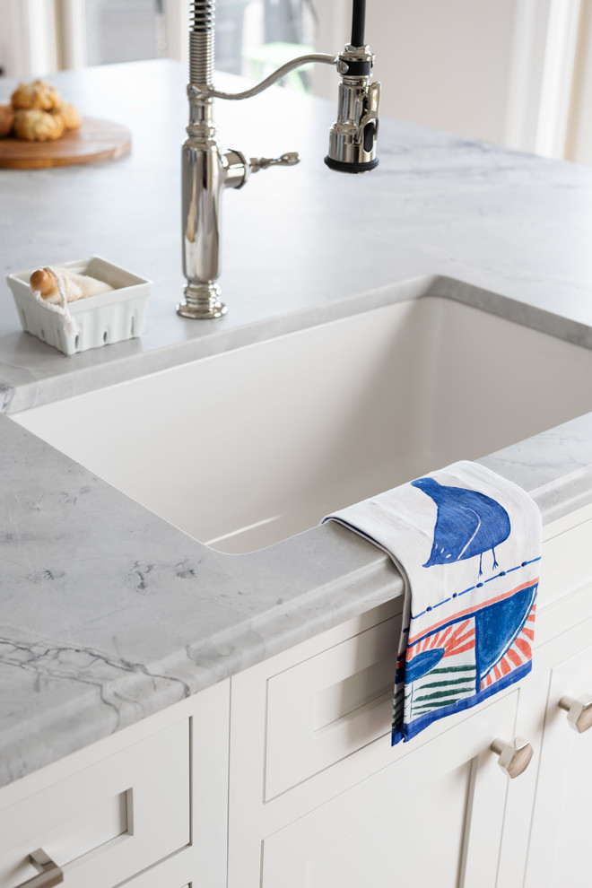 Inspiration for a large transitional l-shaped home design remodel with beaded inset cabinets, quartzite countertops and an island