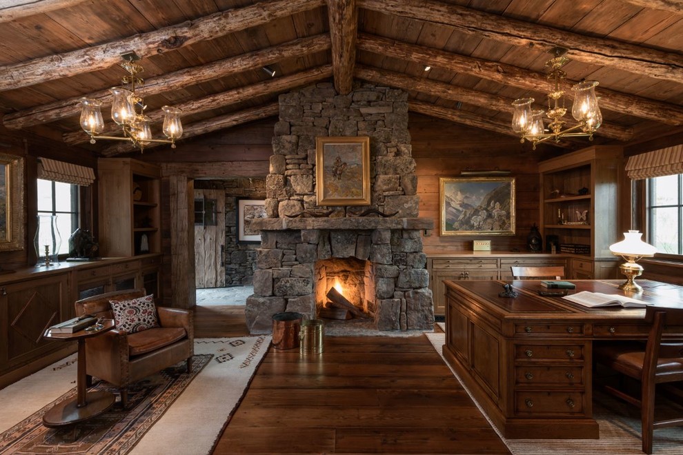 Design ideas for a country home office in Other with dark hardwood floors, a standard fireplace and a stone fireplace surround.