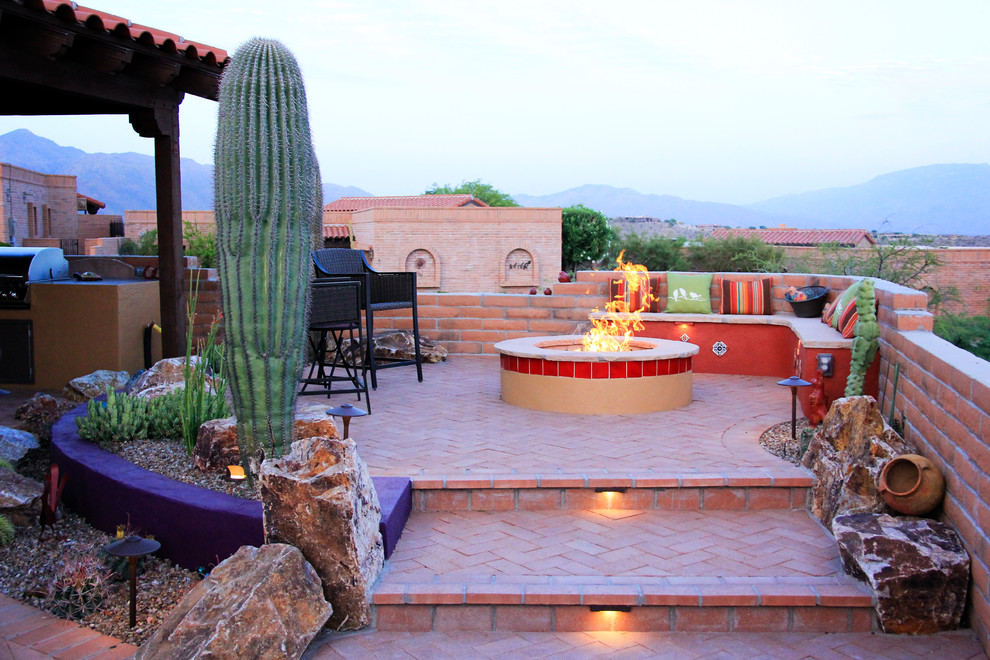 Design ideas for a mid-sized backyard patio in Phoenix with a fire feature, brick pavers and no cover.