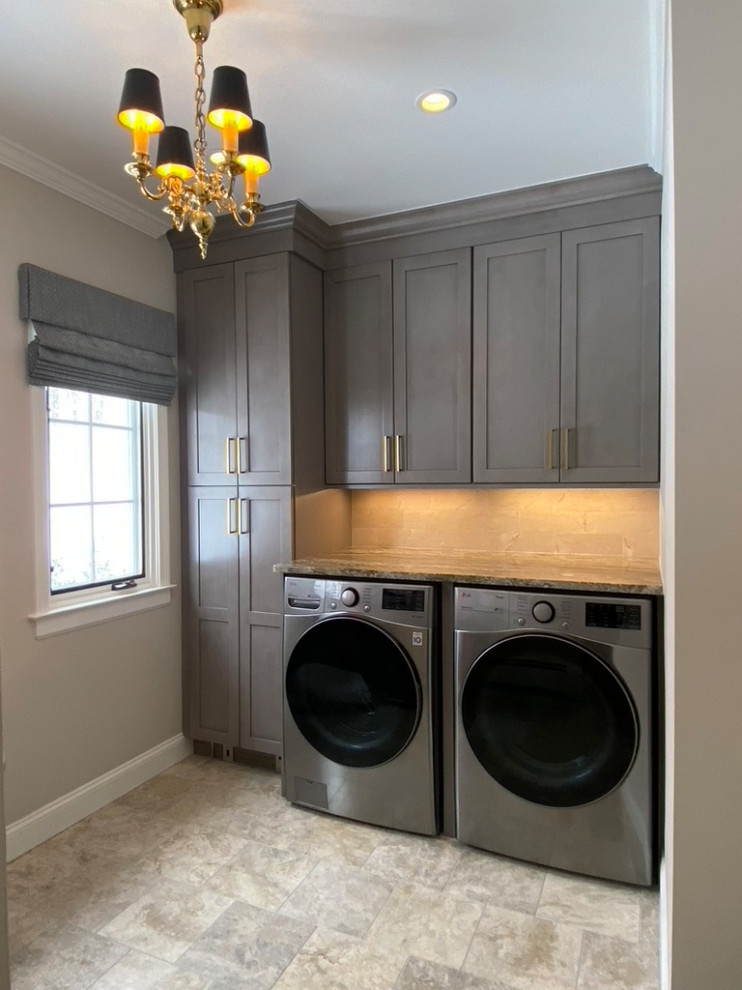 Design ideas for a mid-sized contemporary laundry room in Bridgeport with marble splashback and beige floor.