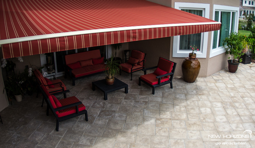 Inspiration for a modern backyard patio in Orlando with an awning.