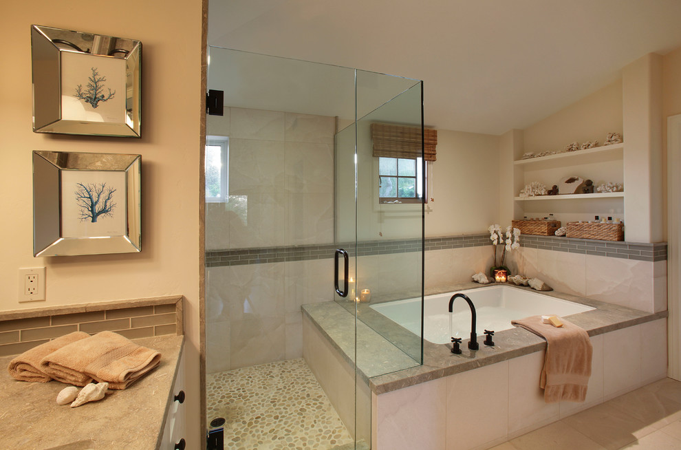 This is an example of a large transitional master bathroom in Orange County with an alcove shower, pebble tile floors, white cabinets, glass tile, beige walls, an undermount sink, granite benchtops, beige tile, an undermount tub, beige floor and a hinged shower door.