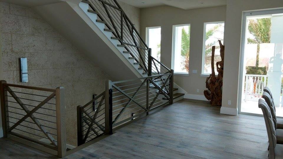 Inspiration for a mid-sized country wood straight staircase in Miami with painted wood risers and mixed railing.