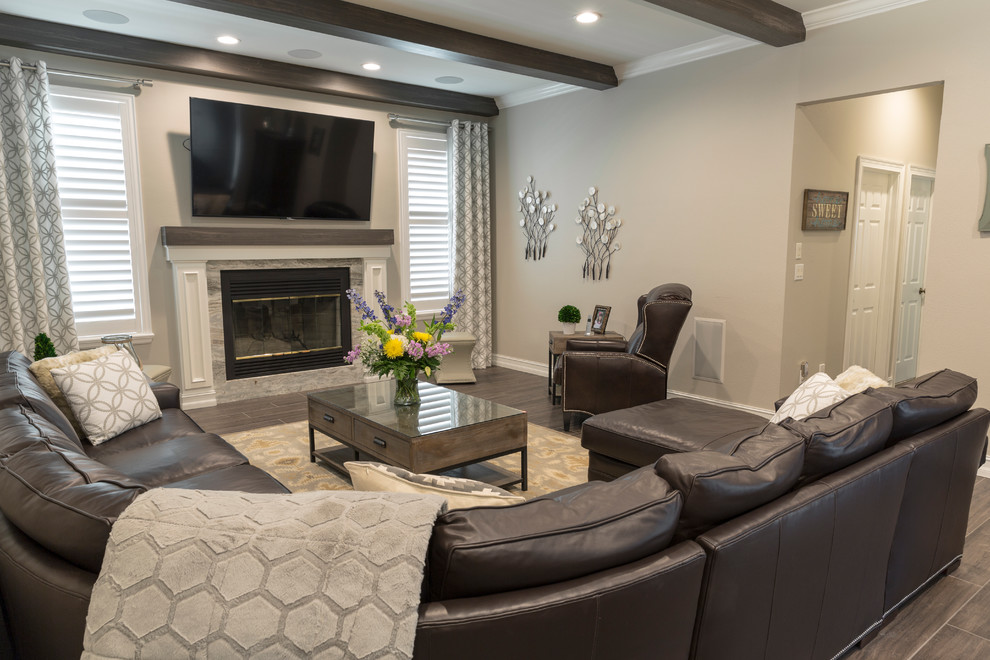 Photo of a mid-sized transitional open concept family room in Tampa with grey walls, porcelain floors, a standard fireplace, a stone fireplace surround and a wall-mounted tv.