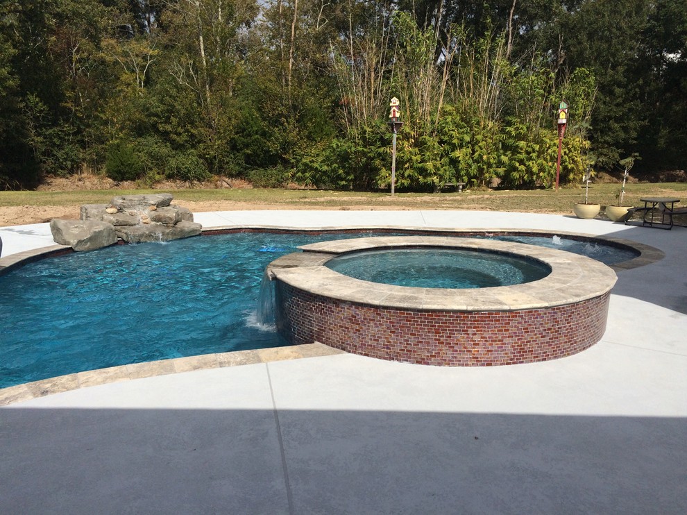 Inspiration for a large contemporary backyard custom-shaped pool in New Orleans with a hot tub and decking.