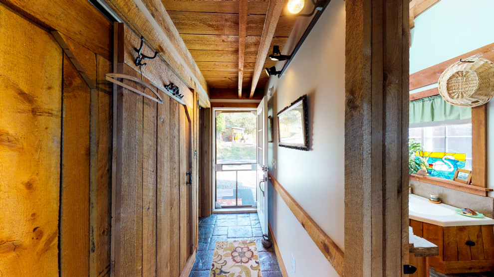 Single front door - small rustic concrete floor and gray floor single front door idea in New York