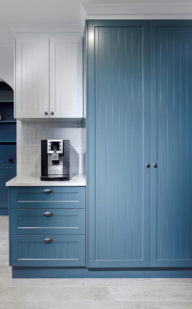 Inspiration for a small traditional u-shaped separate kitchen in Other with an undermount sink, shaker cabinets, blue cabinets, white splashback, subway tile splashback and stainless steel appliances.