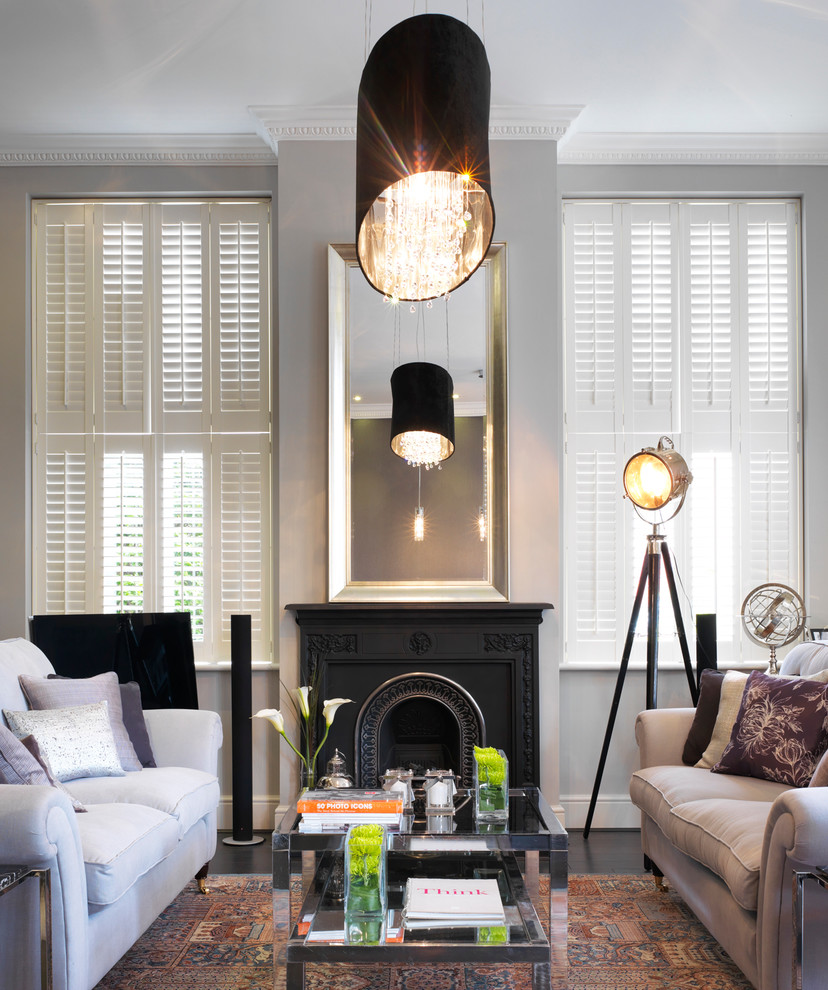 This is an example of a traditional living room in London with grey walls.