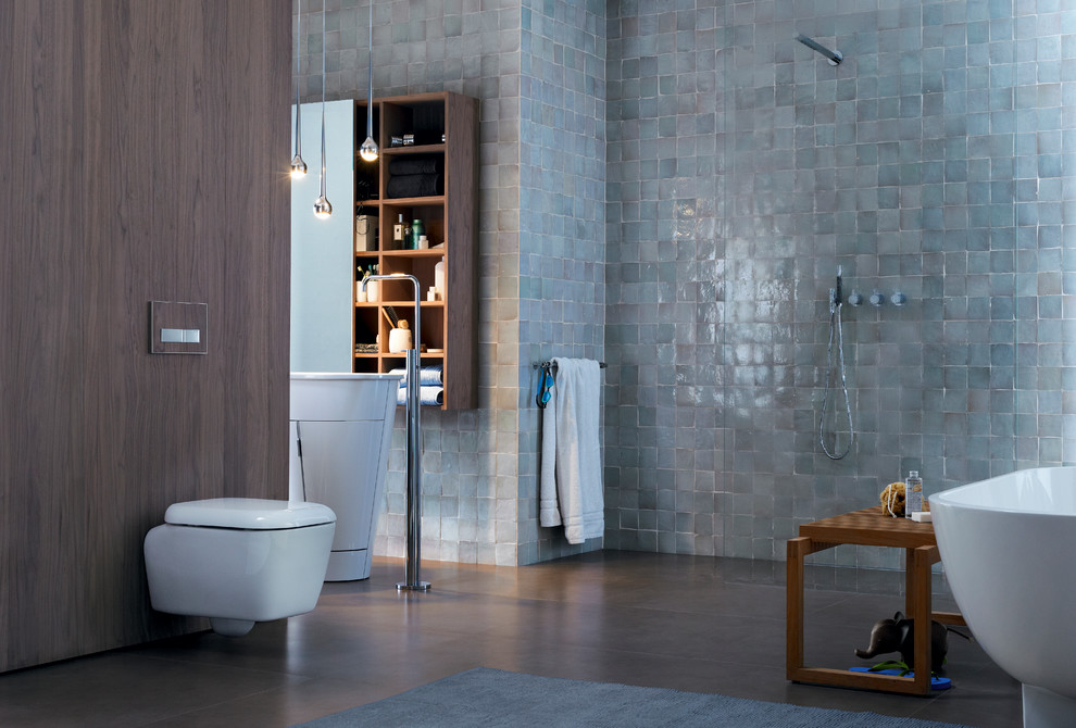 Inspiration for a mid-sized contemporary master bathroom in Chicago with a pedestal sink, glass-front cabinets, dark wood cabinets, a freestanding tub, a curbless shower, a wall-mount toilet, multi-coloured tile, multi-coloured walls and dark hardwood floors.
