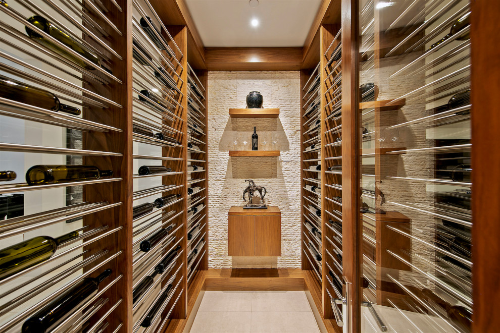 Photo of a contemporary wine cellar in San Diego with display racks and beige floor.