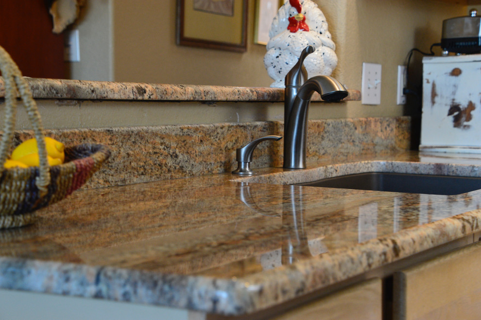 Example of a small mountain style single-wall ceramic tile enclosed kitchen design in Albuquerque with an undermount sink, granite countertops and no island
