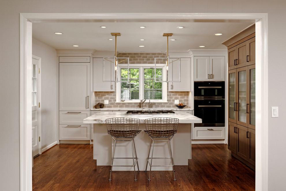 Small 1960s l-shaped medium tone wood floor eat-in kitchen photo in DC Metro with flat-panel cabinets, white cabinets, marble countertops, beige backsplash, paneled appliances, an island, an undermount sink and porcelain backsplash