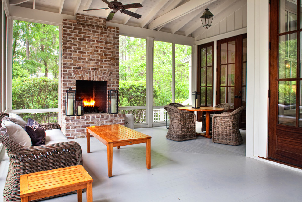 This is an example of a traditional screened-in verandah in Atlanta with a roof extension and decking.
