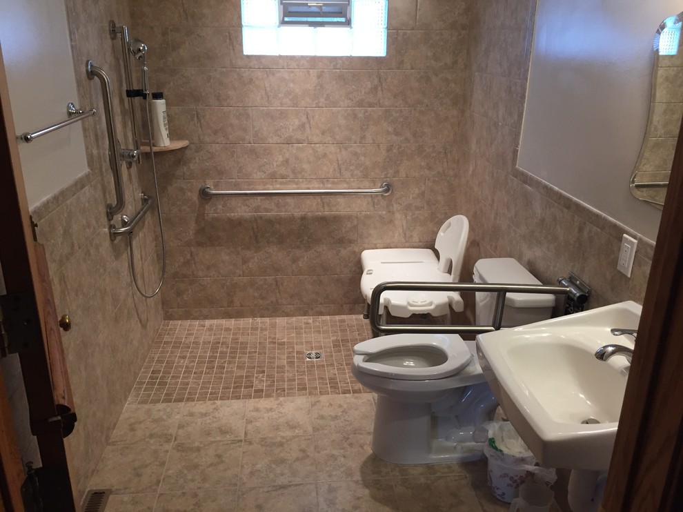 Medium sized ensuite bathroom in Minneapolis with a built-in shower, a two-piece toilet, beige tiles, ceramic tiles, beige walls, terracotta flooring and a wall-mounted sink.