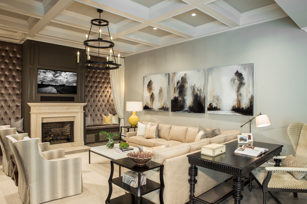 Inspiration for a large traditional family room in Atlanta with grey walls, a standard fireplace, a wall-mounted tv, medium hardwood floors, a stone fireplace surround and brown floor.