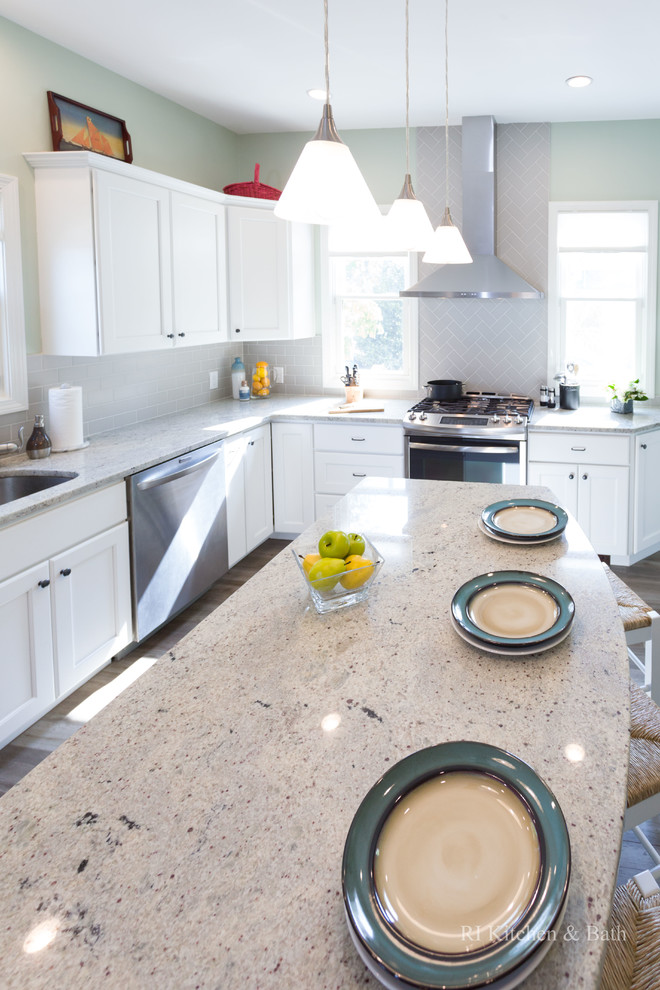 Large transitional l-shaped porcelain tile eat-in kitchen photo in Providence with an undermount sink, recessed-panel cabinets, white cabinets, granite countertops, gray backsplash, ceramic backsplash, stainless steel appliances, green walls and an island