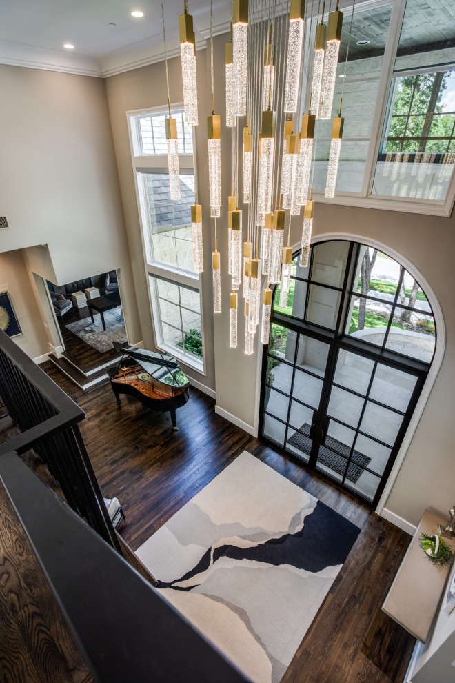 Inspiration for an expansive transitional foyer in Dallas with grey walls, medium hardwood floors, a double front door, a black front door, brown floor and recessed.