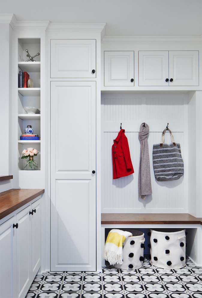 Mudroom - small traditional porcelain tile mudroom idea in Minneapolis with white walls