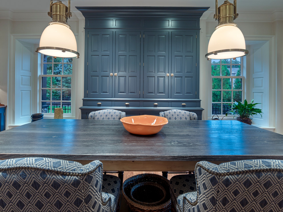 This is an example of a large traditional u-shaped separate kitchen in Philadelphia with raised-panel cabinets, blue cabinets, panelled appliances, medium hardwood floors, with island, an undermount sink, marble benchtops, white splashback, timber splashback, brown floor and white benchtop.