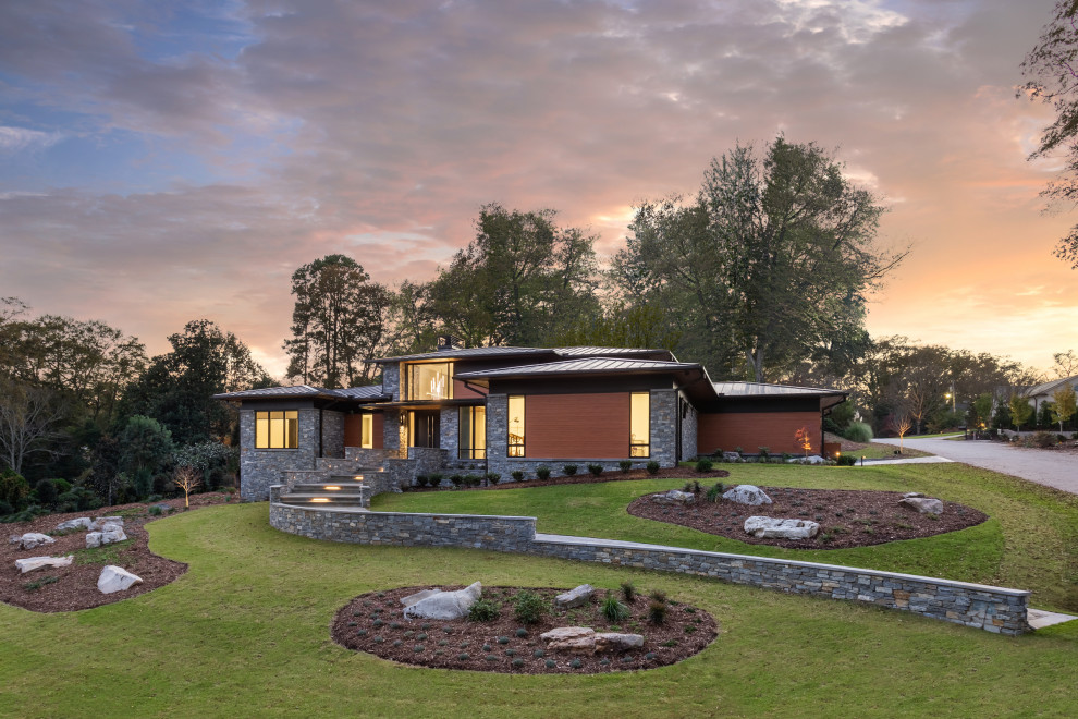 Photo of a large and multi-coloured contemporary bungalow detached house in Other with metal cladding, a metal roof and a black roof.