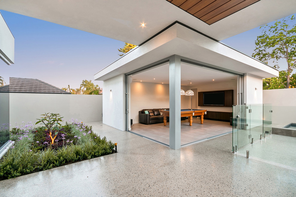 This is an example of a contemporary backyard patio in Perth with a roof extension.