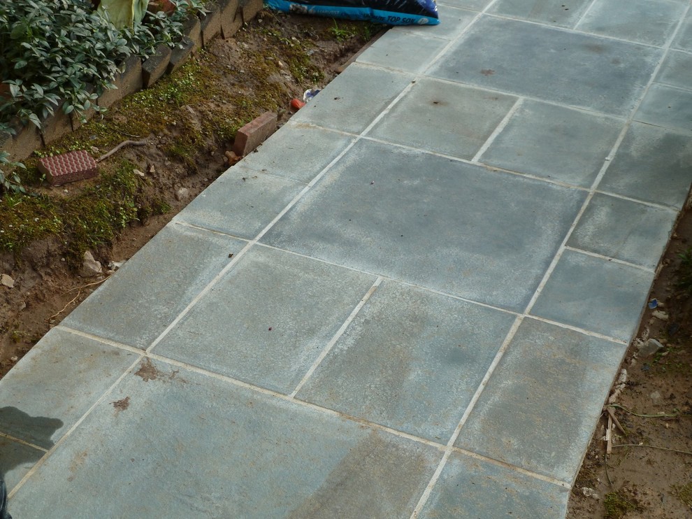 How to edge flagstone path on sloping front yard?