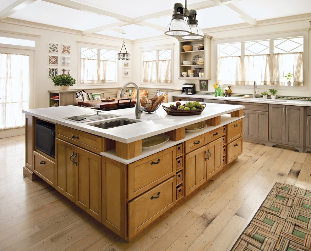Country l-shaped eat-in kitchen in Boston with shaker cabinets, medium wood cabinets, medium hardwood floors and with island.
