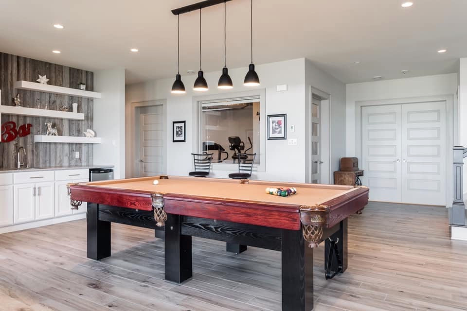 Inspiration for a large transitional walk-out porcelain tile and gray floor basement remodel with gray walls