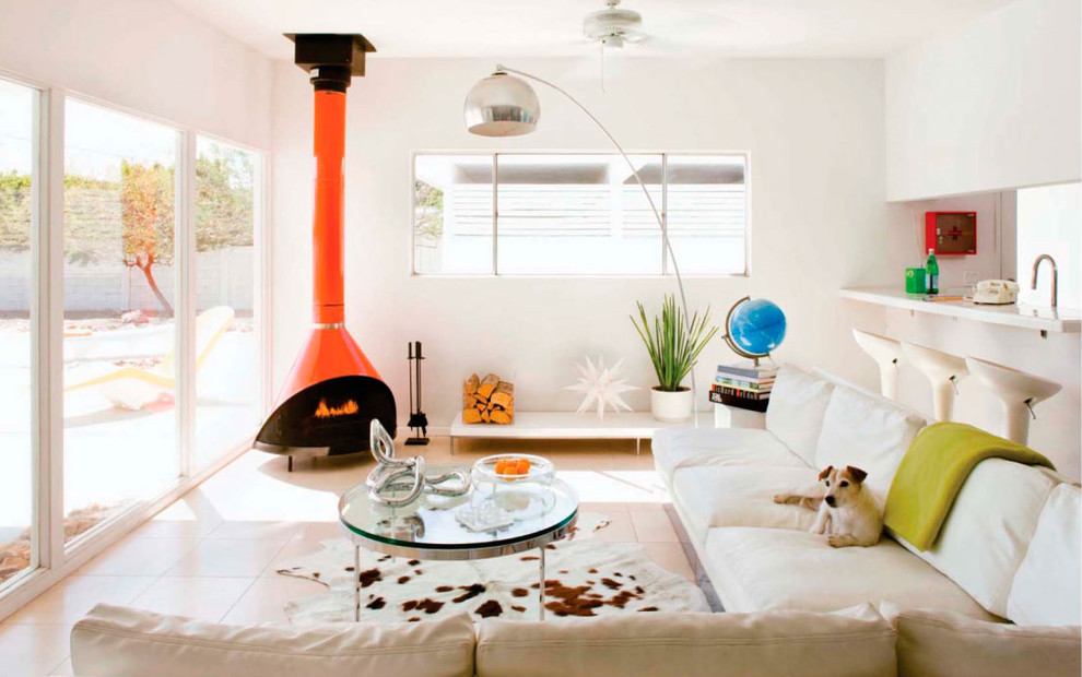 Photo of a large midcentury living room in Los Angeles with white walls and a wood stove.