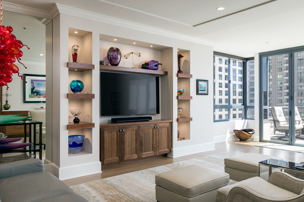 This is an example of a large transitional open concept living room in San Diego with beige walls, light hardwood floors, a built-in media wall and beige floor.