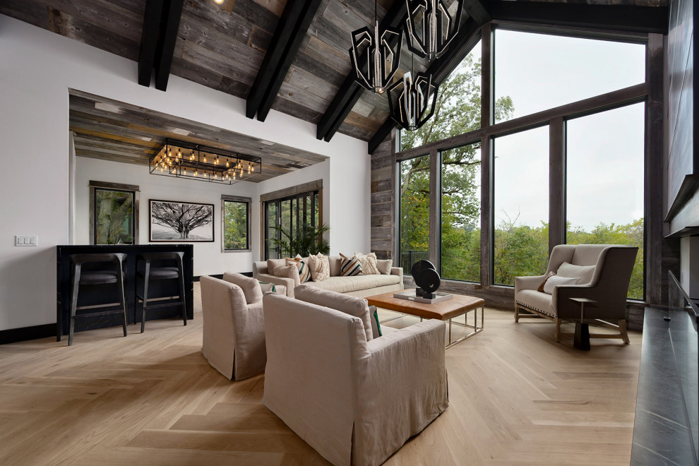 This is an example of a contemporary open concept living room in Kansas City with white walls, light hardwood floors, beige floor, exposed beam, vaulted, wood and wood walls.