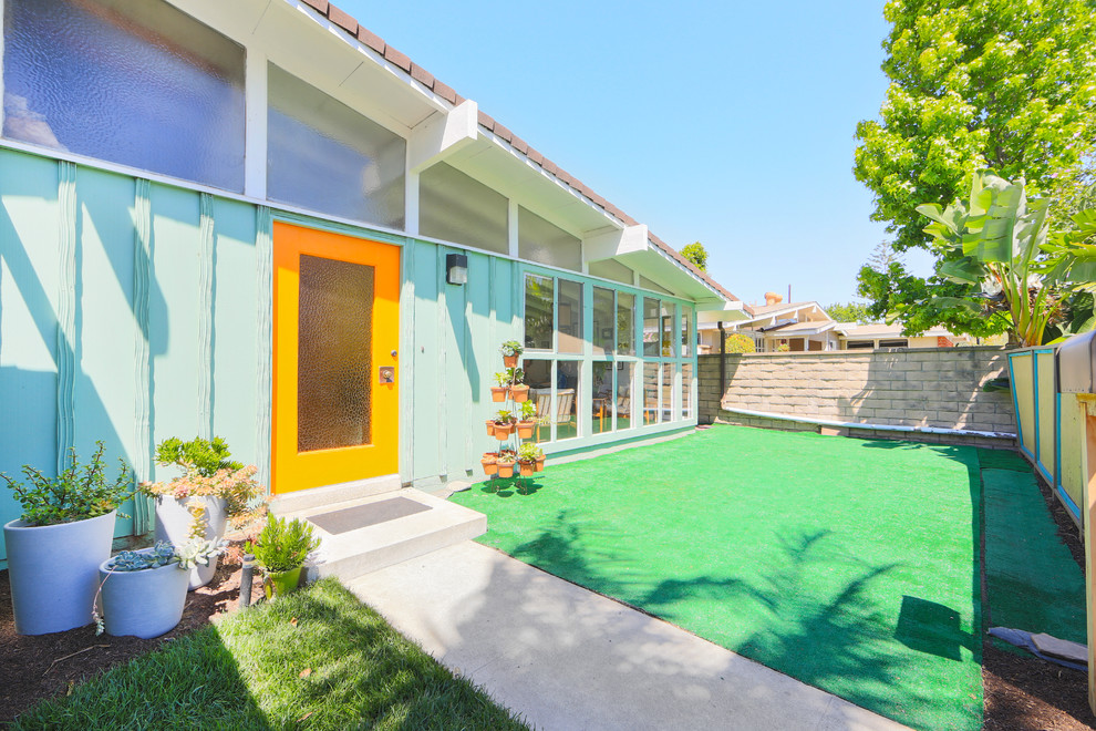 This is an example of a midcentury one-storey blue exterior in Orange County.