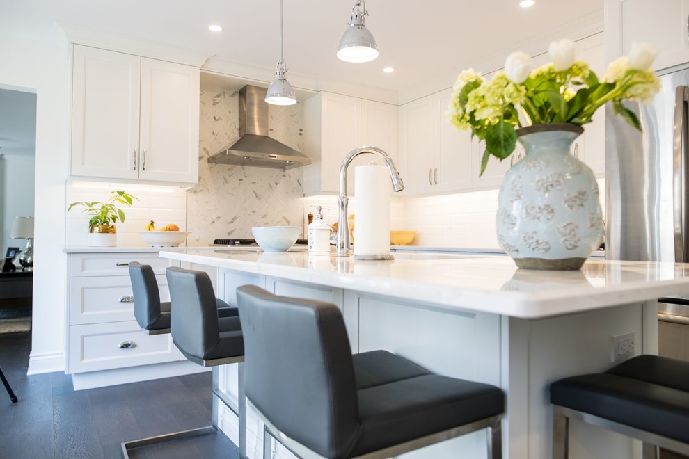 Inspiration for a transitional kitchen in Toronto with shaker cabinets, white cabinets, quartzite benchtops, white splashback, with island and white benchtop.