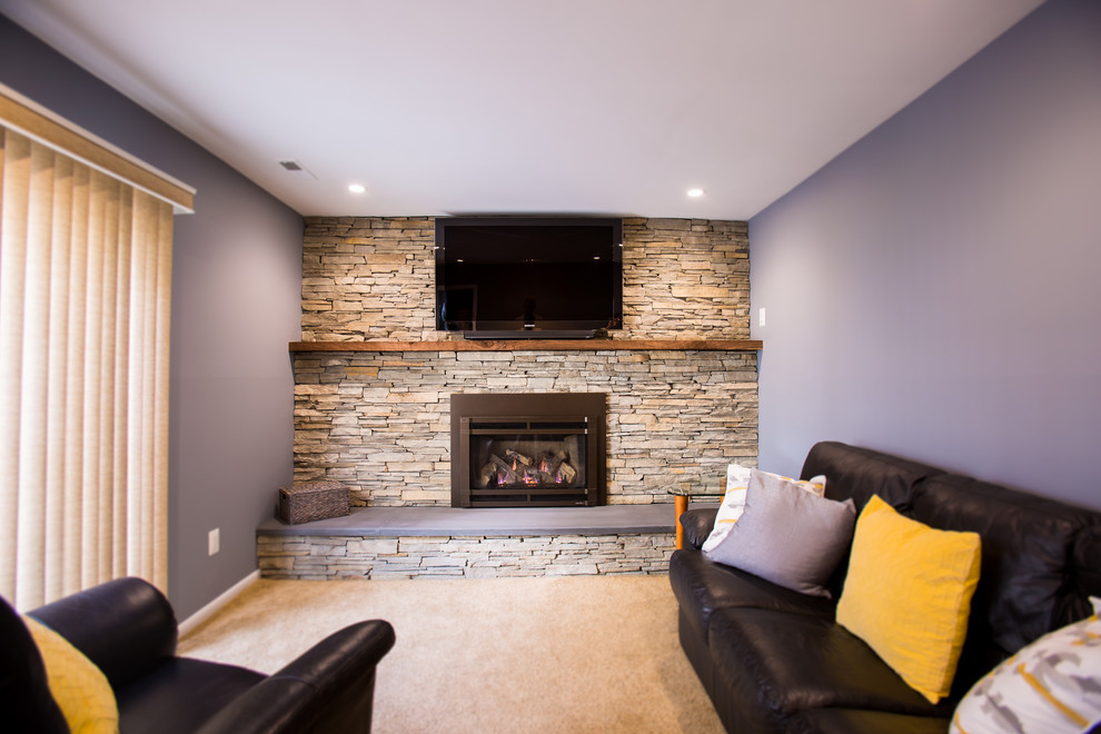 This is an example of a mid-sized country family room in Philadelphia with carpet, a standard fireplace, a stone fireplace surround and a wall-mounted tv.