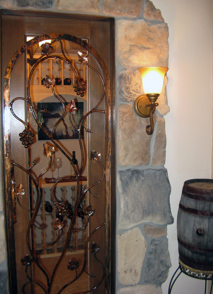 Inspiration for a mid-sized mediterranean wine cellar in Denver with porcelain floors and storage racks.