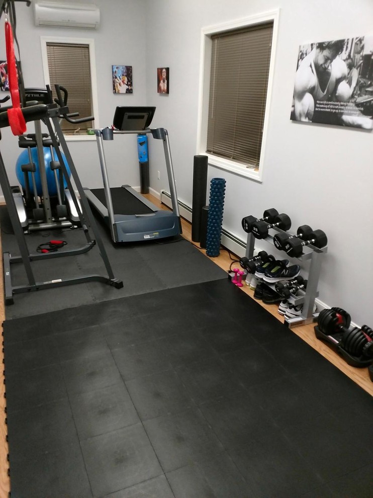 Small multipurpose gym in Minneapolis with white walls and black floor.