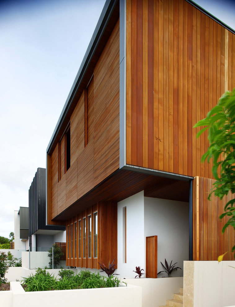 This is an example of a large contemporary front door in Brisbane with white walls.