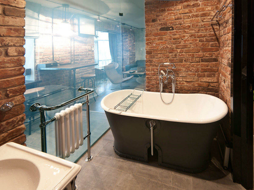 Inspiration for an industrial bathroom in Moscow with a freestanding tub.