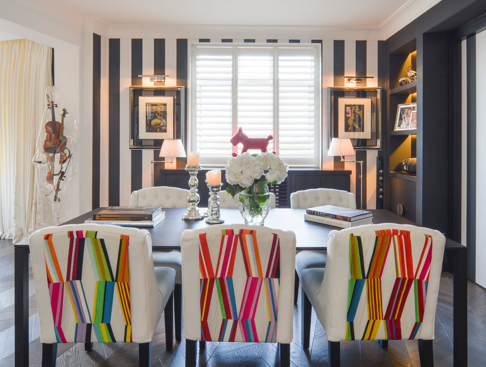 Mid-sized eclectic dining room in London with multi-coloured walls, dark hardwood floors and black floor.