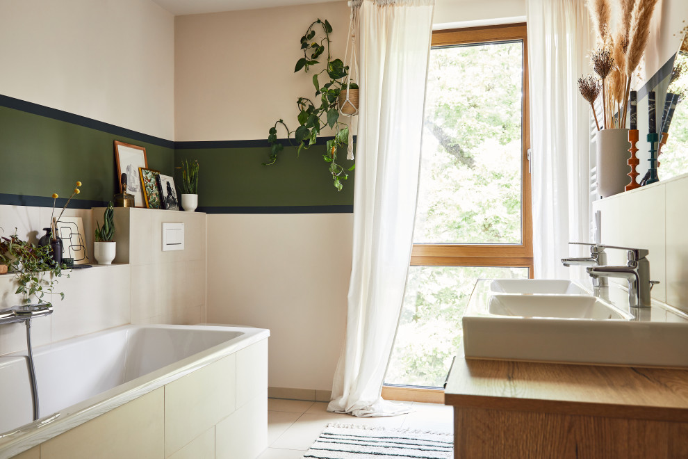 This is an example of a medium sized contemporary bathroom in Hamburg with flat-panel cabinets, medium wood cabinets, double sinks and a floating vanity unit.