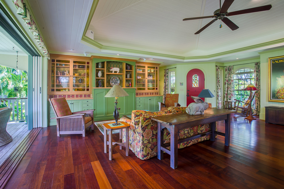 This is an example of a mid-sized arts and crafts formal open concept living room in Hawaii with green walls, medium hardwood floors and no tv.