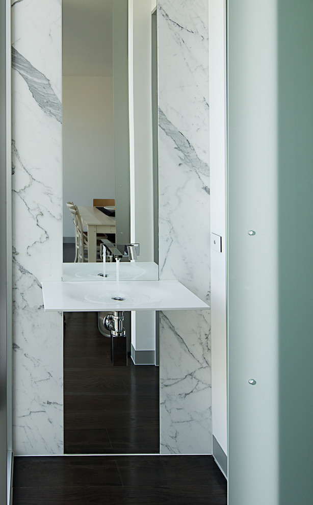 Small modern powder room in Melbourne with a wall-mount sink, dark hardwood floors, stone slab and white walls.